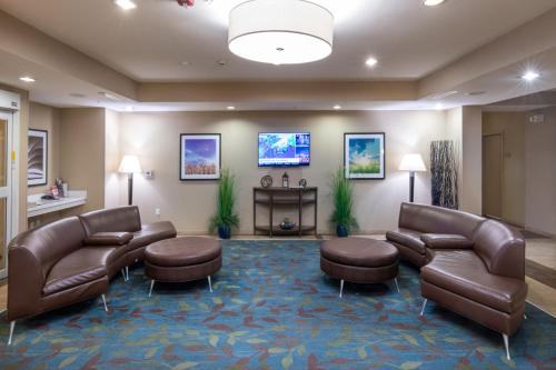 a waiting room with couches and chairs and a table at Candlewood Suites Enid, an IHG Hotel in Enid