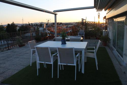 a white dining table and chairs on a patio at Suite CielAzzurro in Arezzo
