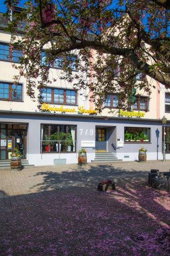 a building with a dog laying in front of it at Hotel-Restaurant Weinhaus Grebel in Koblenz