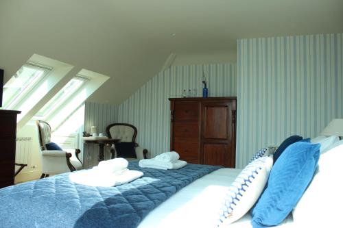 a bedroom with a blue and white bed with pillows at Inch Beach House B&B in Inch