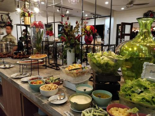 a buffet with bowls of food on a counter at Momarco Forest Cove in Tanay