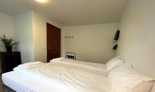 a bedroom with a large white bed with two pillows at Day Dream Soleyjargata Rooms & Apartments in Reykjavík