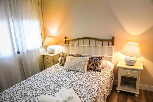 Postel nebo postele na pokoji v ubytování Apartamentos Baeza RN
