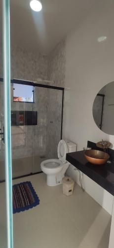 a bathroom with a toilet and a sink at Casa com vista incrível para o Lago de Furnas in Capitólio