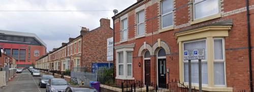 a row of brick buildings on a city street at Hosted By Ryan - Anfield Apartments in Liverpool