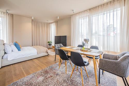 a living room with a bed and a table and chairs at Tamara Suites & Apartments in Jūrmala