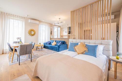 a bedroom with a bed and a living room at Tamara Suites & Apartments in Jūrmala