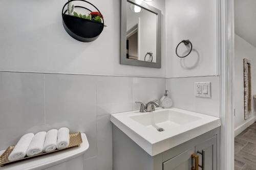 a white bathroom with a sink and a mirror at Casa Del Sol in Hollywood