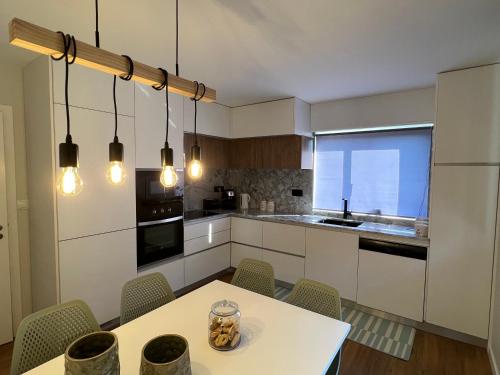 a kitchen with a table and chairs in a room at Casa das Flores I in Paredes de Coura