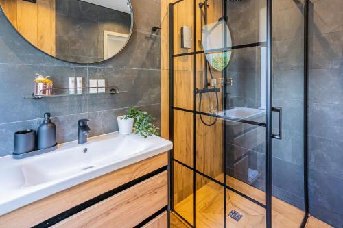 a bathroom with a sink and a shower at Tamara Suites & Apartments in Jūrmala