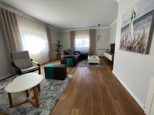 a living room with a couch and a table at Casa das Flores I in Paredes de Coura