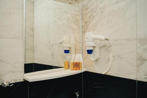 a bathroom with a shower with a mirror and a sink at Hotel - Villa Lejla in Mostar