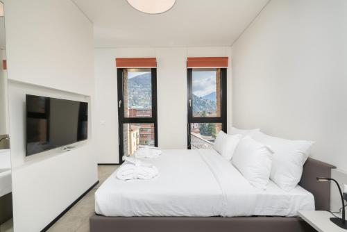 A bed or beds in a room at Swiss Hotel Apartments - Lugano