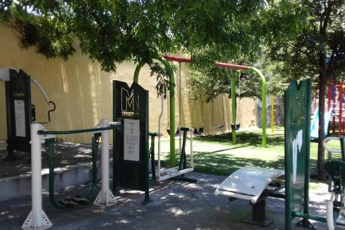 a park with a bunch of gates and a playground at Acogedor Departamento con estacionamiento gratuito in Monterrey