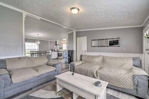 a living room with two couches and a table at Chic Seneca Falls Home on Cayuga Wine Trail! in Seneca Falls
