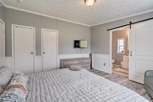 a bedroom with a large bed and a television at Chic Seneca Falls Home on Cayuga Wine Trail! in Seneca Falls