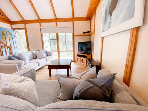 a living room with two couches and a tv at Ocean View walk to the beach & Surfers Point - Margaret River Properties in Prevelly
