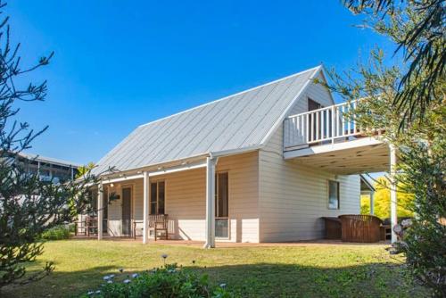 a large house with a porch and a balcony at Ocean View walk to the beach & Surfers Point - Margaret River Properties in Prevelly