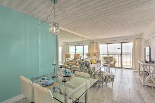 a living room with a glass table and chairs at Ocean-View Balcony and Pool Access Galveston Gem! in Galveston