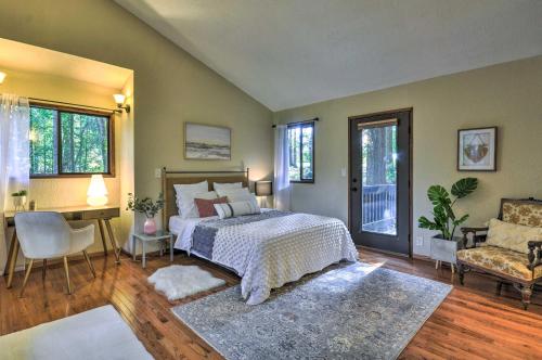 A bed or beds in a room at Cozy Sandy Retreat with Hot Tub and Forest Views!