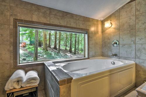 A bathroom at Cozy Sandy Retreat with Hot Tub and Forest Views!