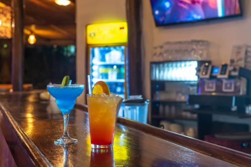 two cocktails sitting on top of a bar at Hotel Pasatiempo in Tamarindo