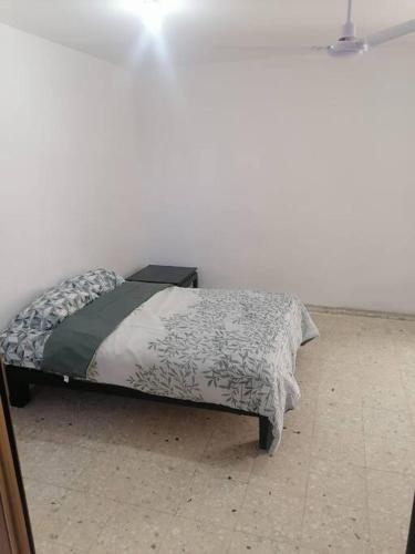 a bed in a white room with at Hermoso departamento en Mazatlán in Mazatlán
