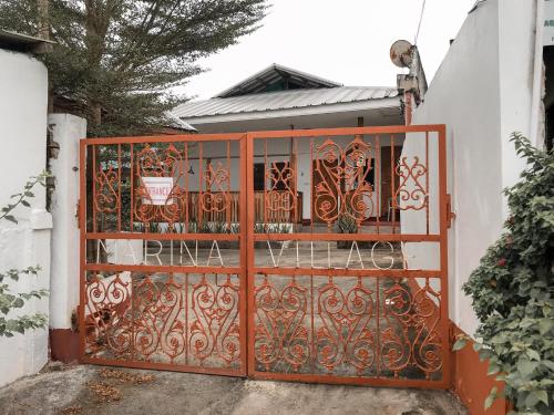 an orange gate in front of a house at Marina Village in Moalboal