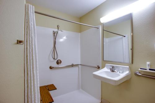 a bathroom with a sink and a shower at Candlewood Suites Raleigh Crabtree by IHG in Raleigh