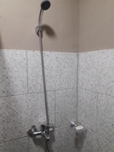 a shower in a bathroom with a shower head at Cabañas Samay in Funes