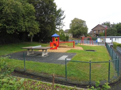 a park with a playground with a picnic table and a bench at Apartment with terrace and pool in the garden in Pracht