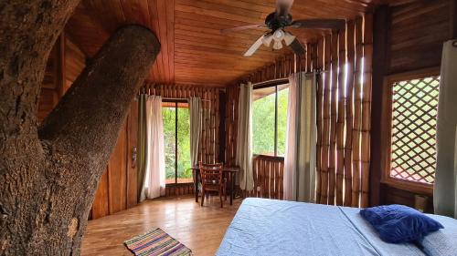 a bedroom with a bed and a ceiling fan at Finca Lucky, Samara in Sámara