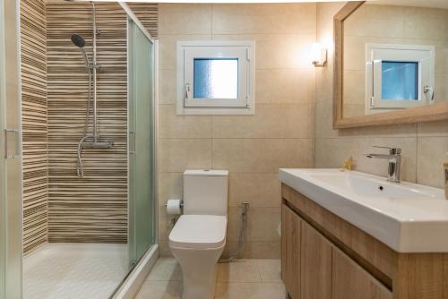 a bathroom with a toilet and a sink and a shower at Katerina Residence in Zakynthos Town