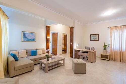 a living room with a couch and a desk at Katerina Residence in Zakynthos Town