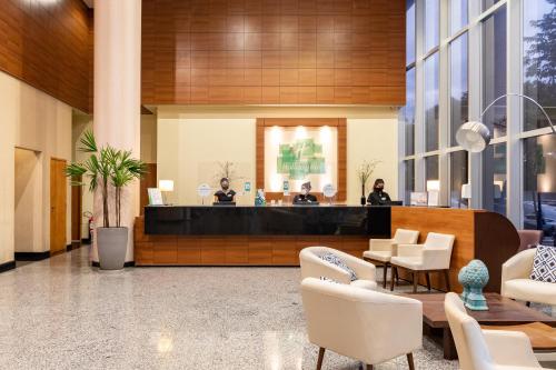 a lobby with a reception desk in a building at Holiday Inn Manaus by IHG in Manaus