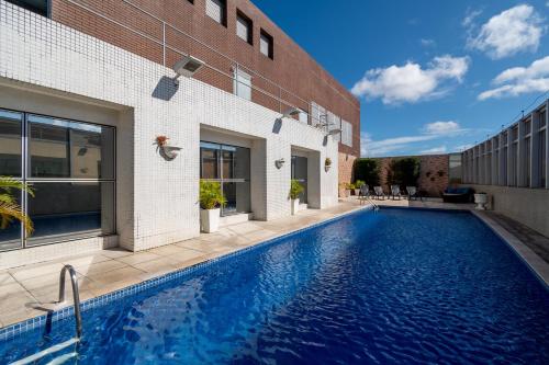 a swimming pool in front of a building at Holiday Inn Manaus by IHG in Manaus