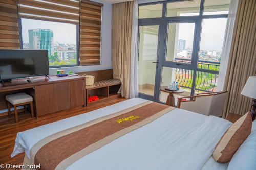 a bedroom with a large bed and a large window at Khách sạn Thái Bình Dream in Thái Bình