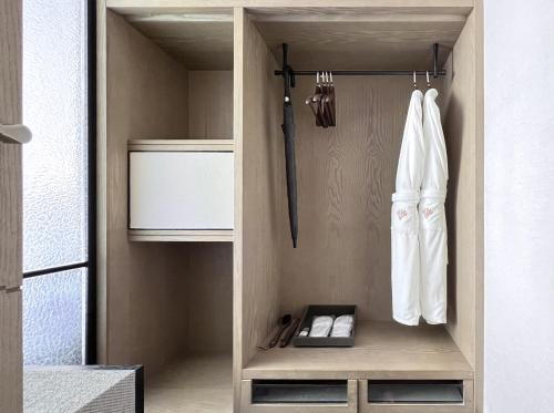 a walk in closet with white utensils in it at Empark Grand Hotel Beijing in Beijing
