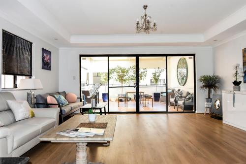 a living room with a couch and a table at Ganesha Wellness Spa in Perth