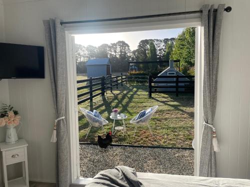 a sliding glass door with a view of a yard at Farm Stay HARMONY Cottage at Wilindi Estate in Tyabb