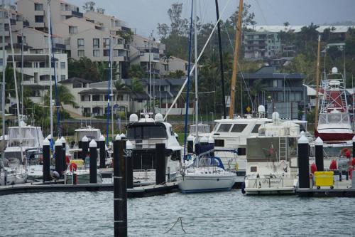 a group of boats docked in a harbor with buildings at Airlie Seaview Apartments in Airlie Beach