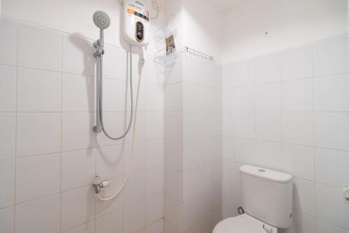 ein weißes Badezimmer mit Dusche und Toilette in der Unterkunft RedLiving Apartemen Gunung Putri - SIROOMS in Parungtandjung