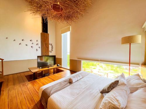 A bed or beds in a room at HALO Sustainable Resort Karimunjawa