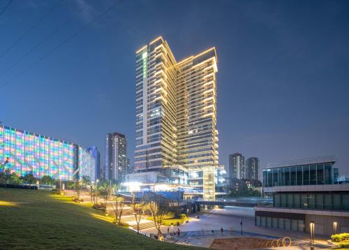 a rendering of a tall building in a city at night at Holiday Inn Express Chongqing Caiyun Lake by IHG in Chongqing