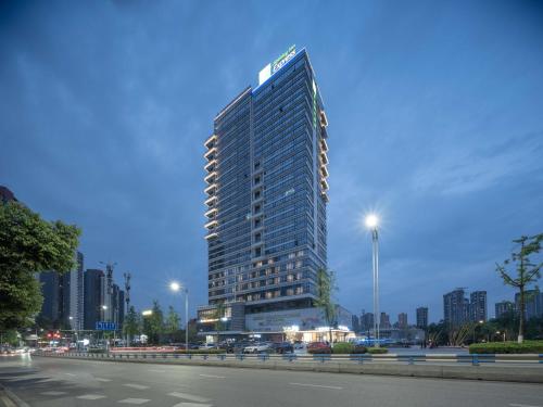 a tall building with a sign on top of it at Holiday Inn Express Chongqing Caiyun Lake by IHG in Chongqing