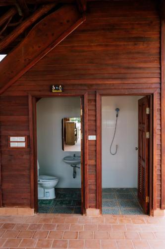 a bathroom with a toilet and a sink at Tayama Farm Khaoyai in Nakhon Ratchasima