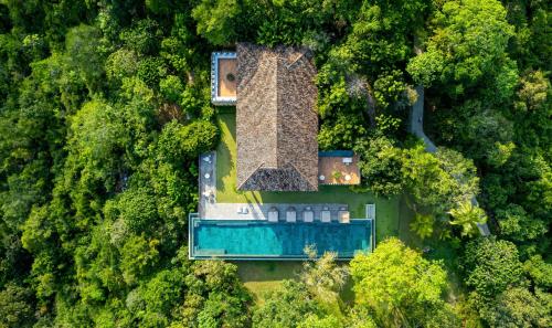 an overhead view of a house with a pool in the forest at Malabar Hill in Weligama