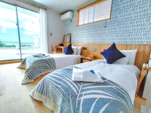 Ένα ή περισσότερα κρεβάτια σε δωμάτιο στο Ocean View Ishigaki Sora and Umi