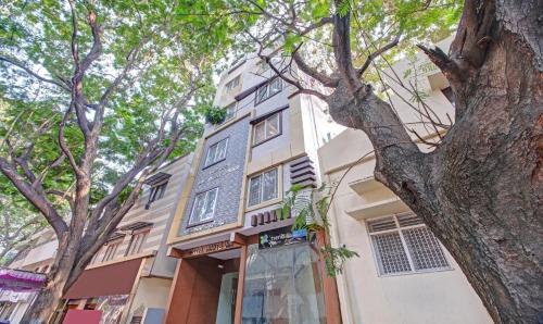 a building with a tree in front of it at Treebo White Inn in Bengaluru