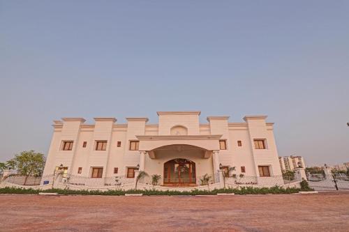 a large white building with a large entrance at Ratna Vilas Palace in Rajkot